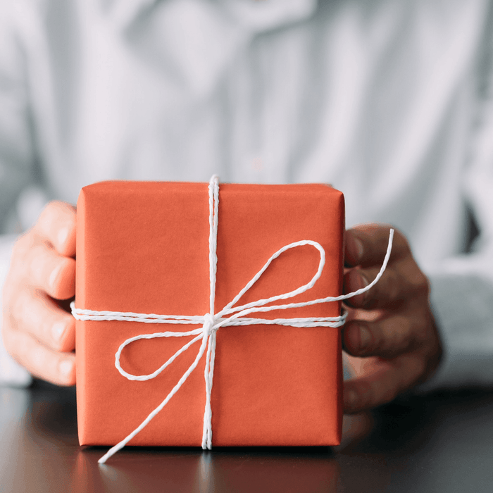 man giving a box of corporate gifts in Singapore