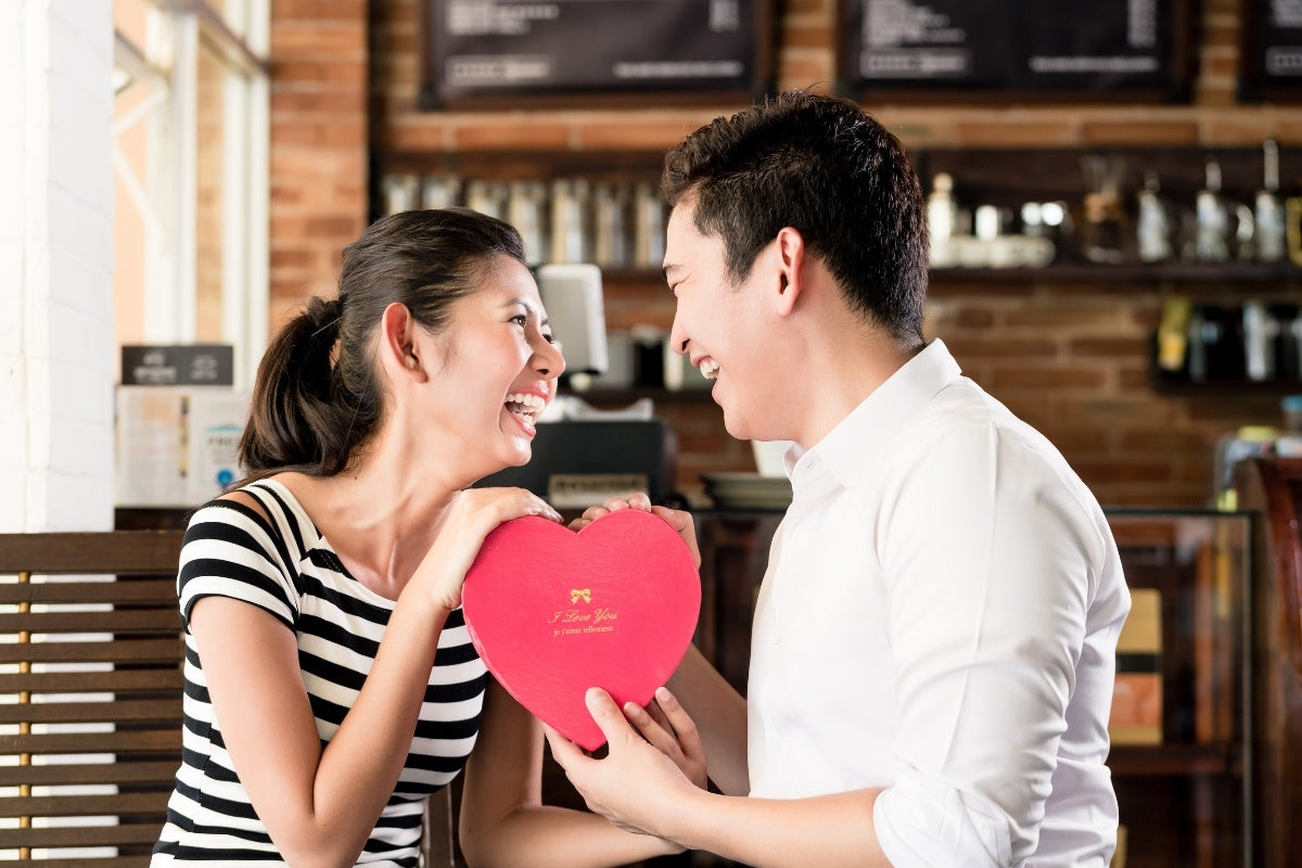 Asian Couple Having Date with Anniversary Gift in Between