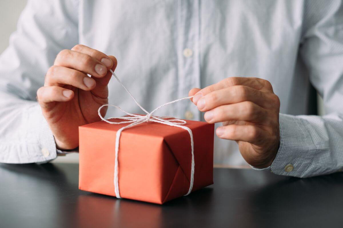 businessman opening a gift from a corporate gift supplier