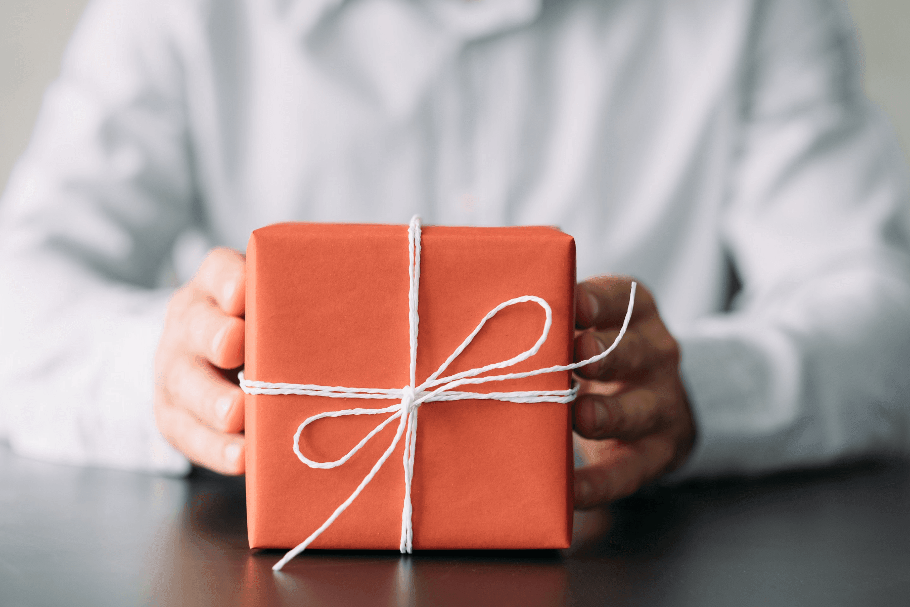 man giving a box of corporate gifts in Singapore