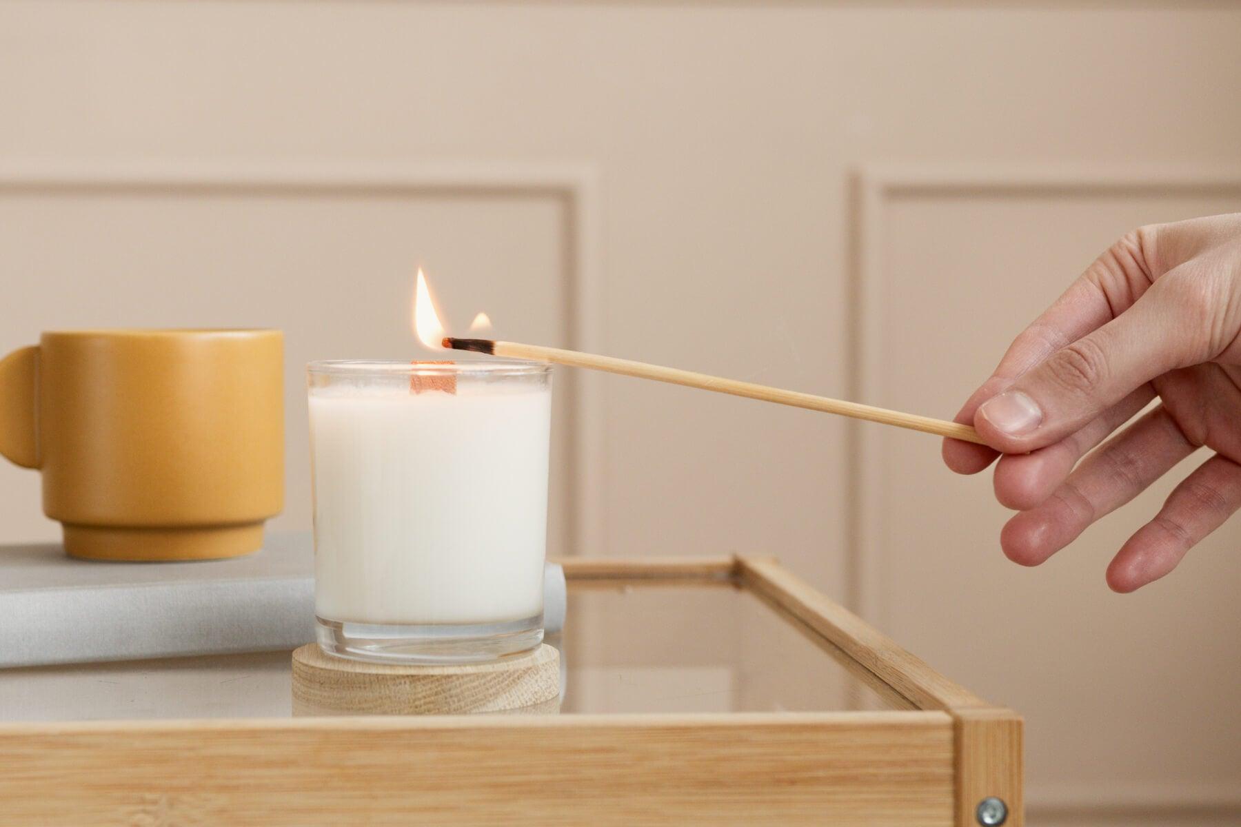 woman's hand lighting affordable scented candles