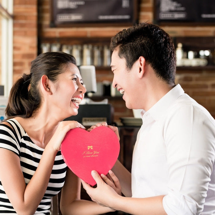 Asian Couple Having Date with Anniversary Gift in Between