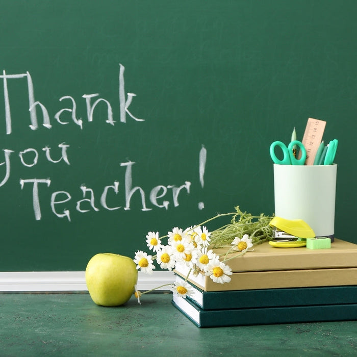 Books with Flowers, Apple, Stationery and Text THANK YOU TEACHER on Color Background