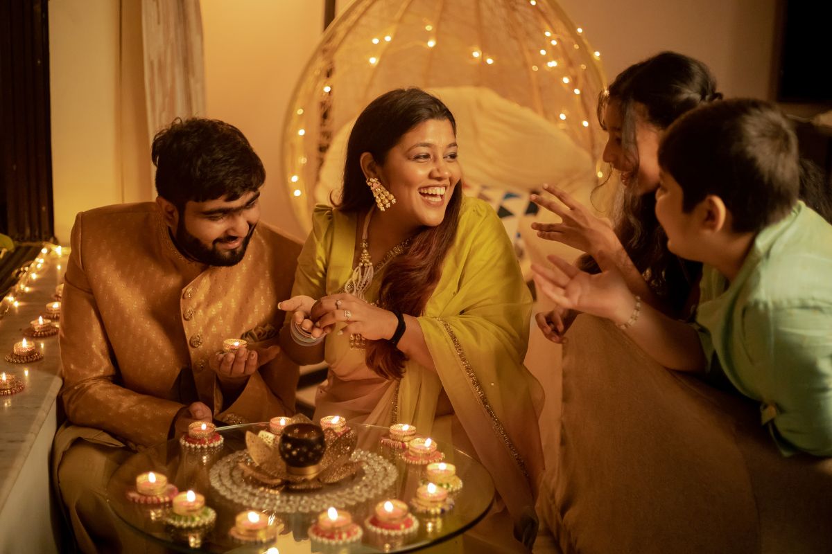 Family with Lighted Candles Celebrating Diwali at Home