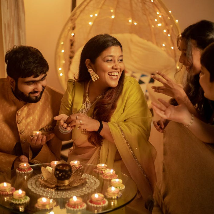 Family with Lighted Candles Celebrating Diwali at Home