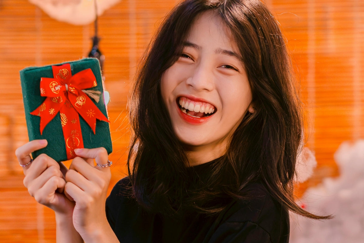 Smiling Woman with Christmas Corporate Gift Box