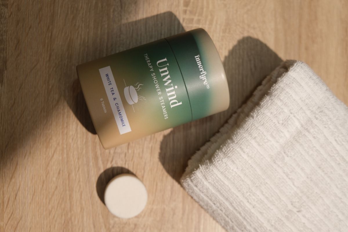 unwind shower steamer with bath towel