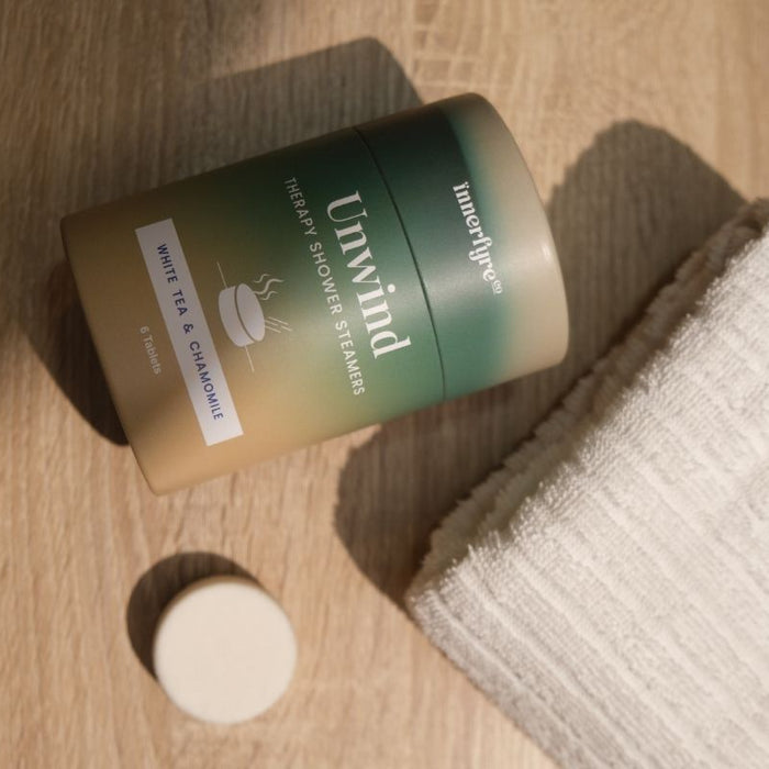 unwind shower steamer with bath towel