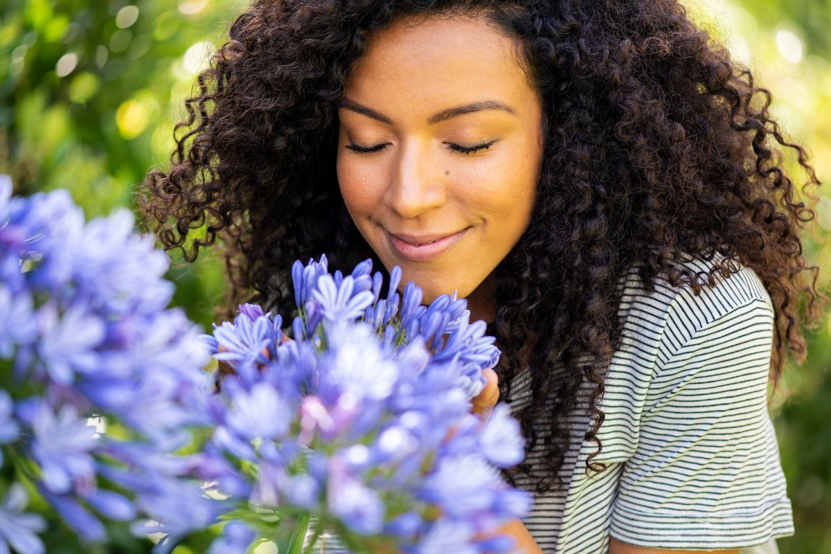 Young woman smelling flowers