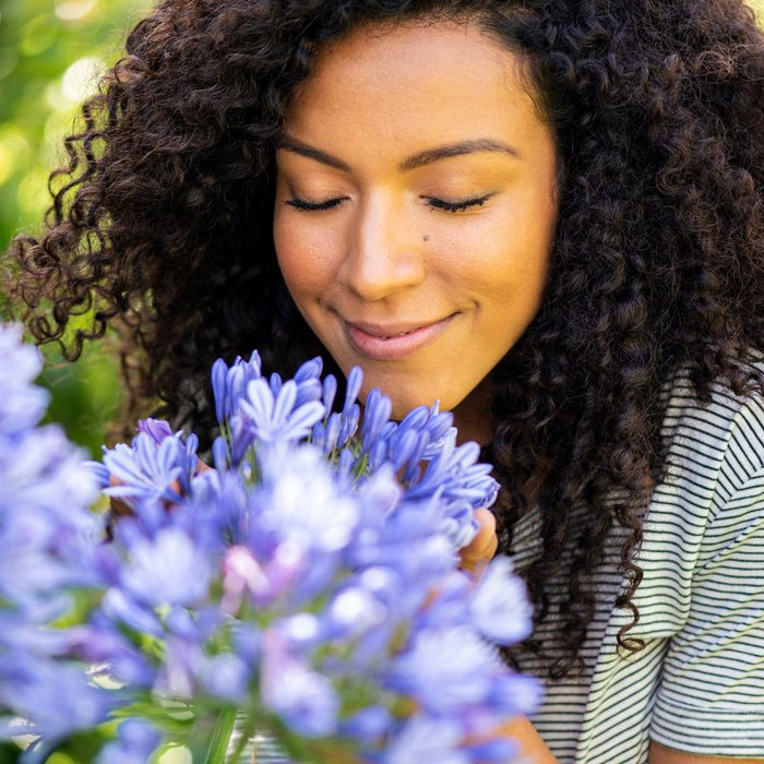 Young woman smelling flowers