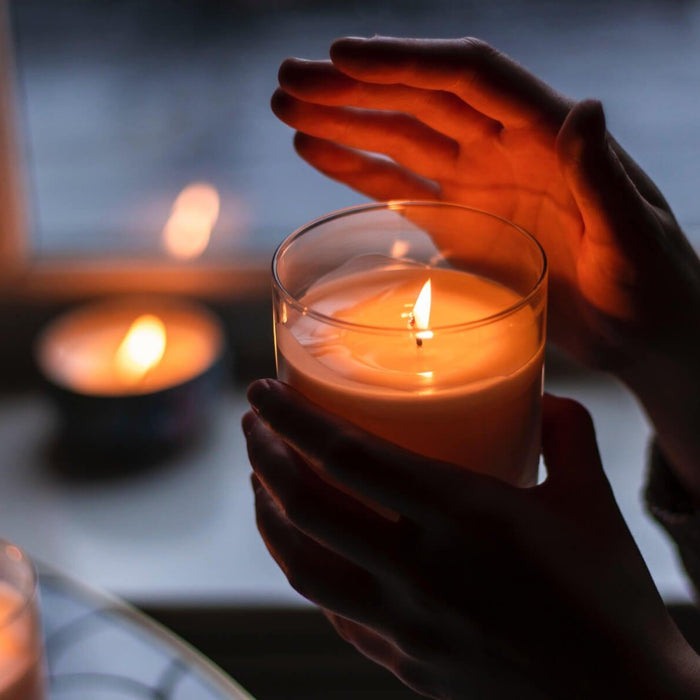 person's hand showing how to make scented candles last longer