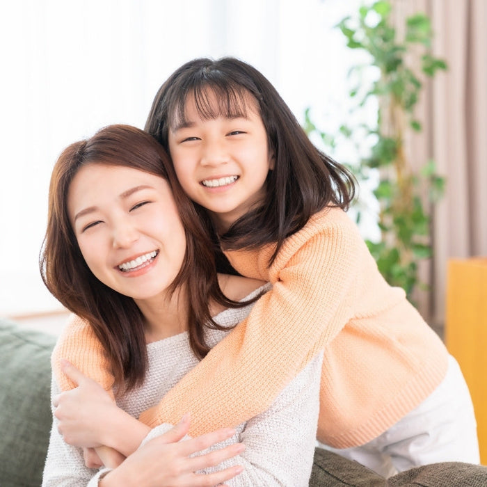 asian mother and daughter hugging on her birthday