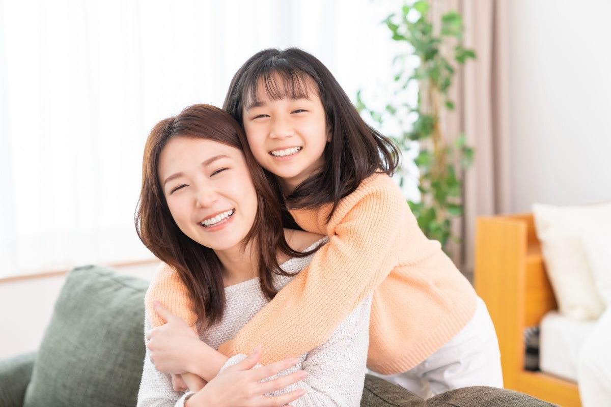 asian mother and daughter hugging on her birthday