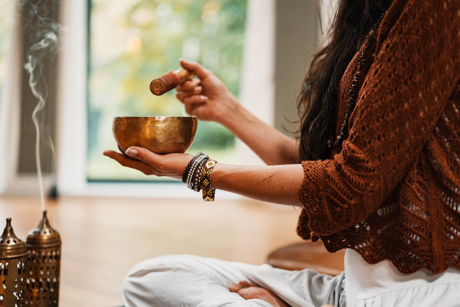 woman meditating with incense