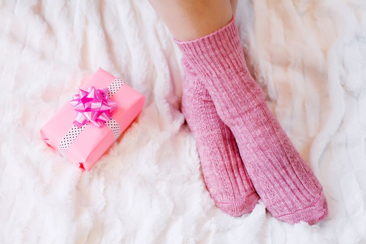 pink gift box on top of bed