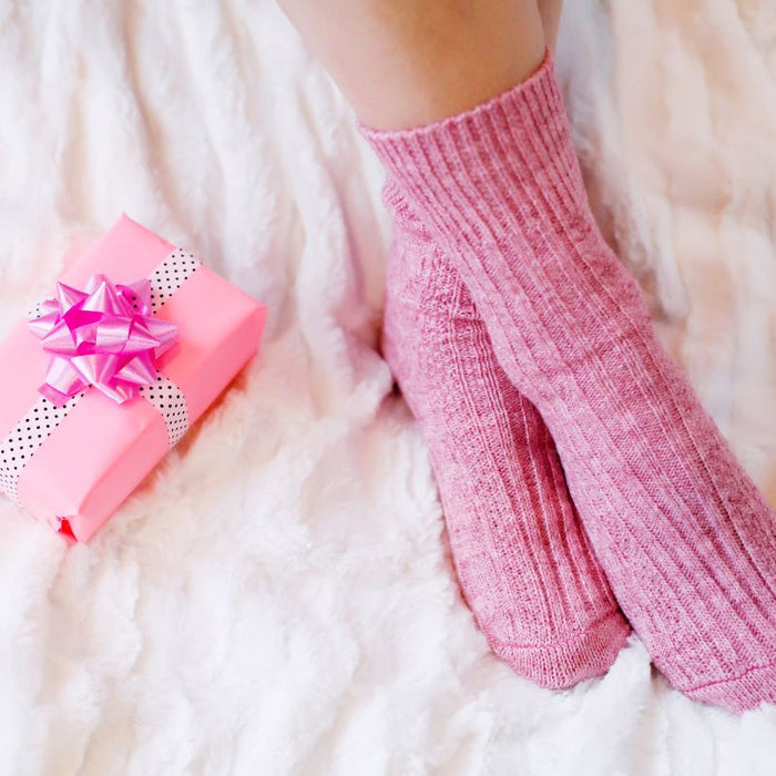 pink gift box on top of bed